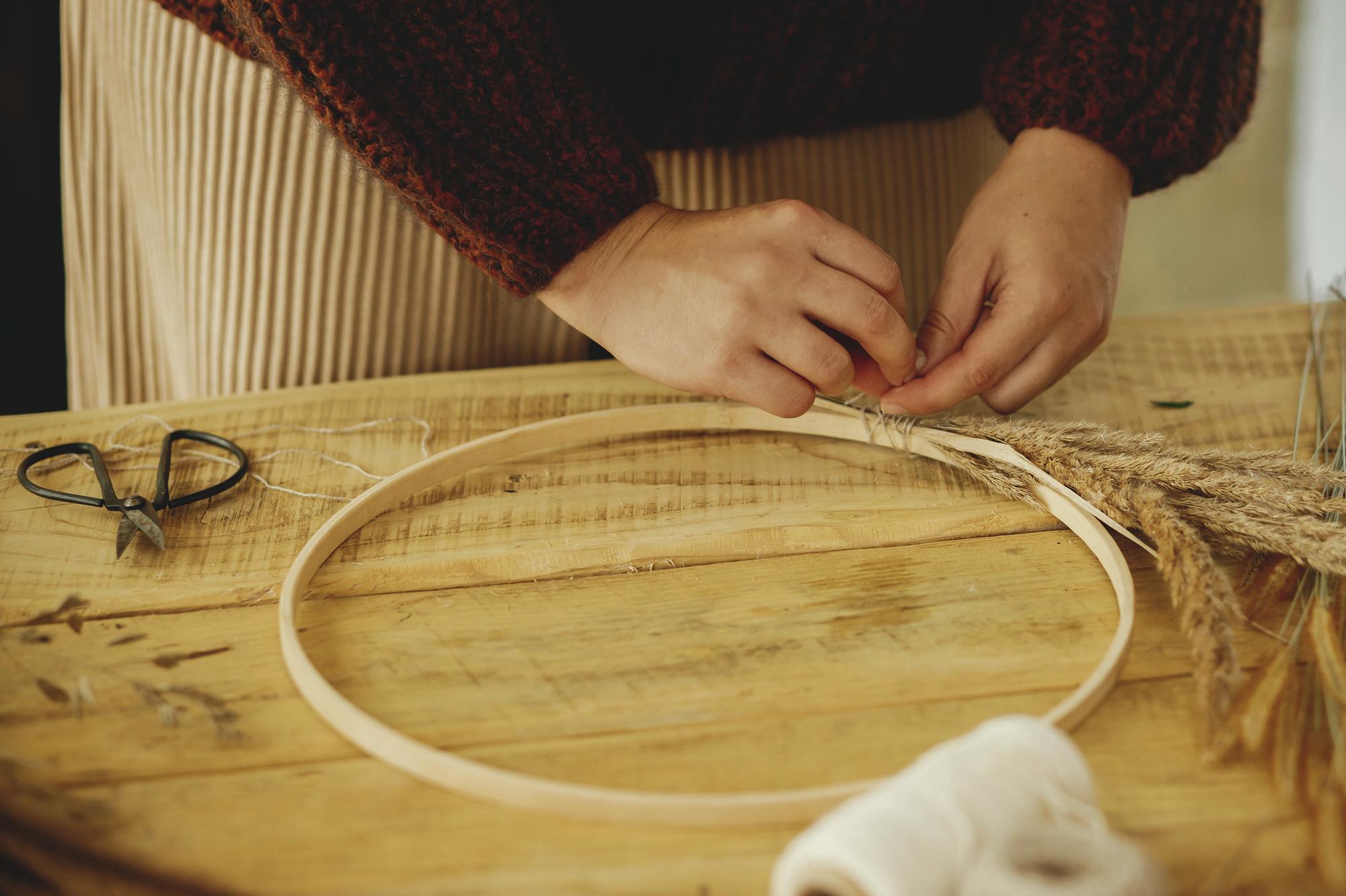 Artisan at work stitching a monogram by hand