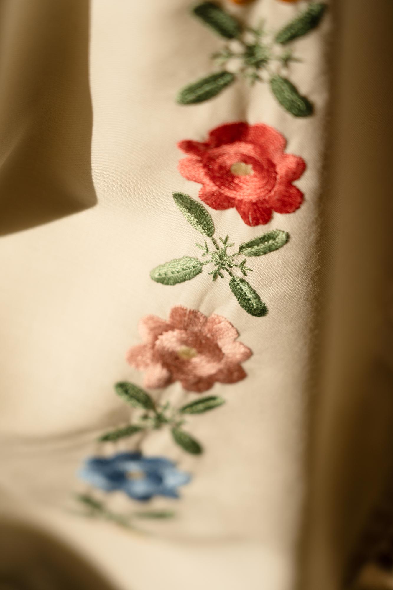 Close-up of embroidered floral motif on linen